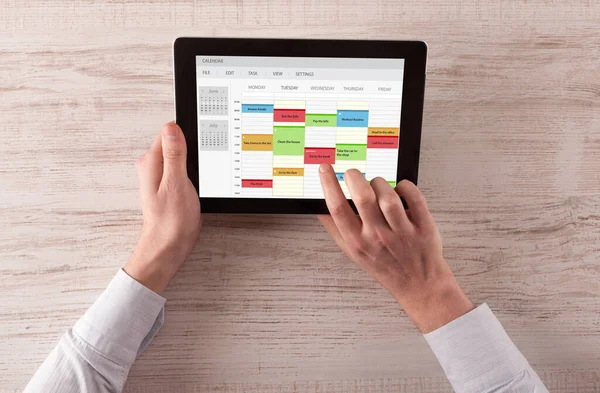 Hand holding tablet with timetable concept — Stock Photo, Image