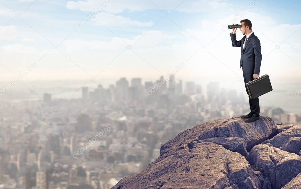 Business person looking to the city from distance