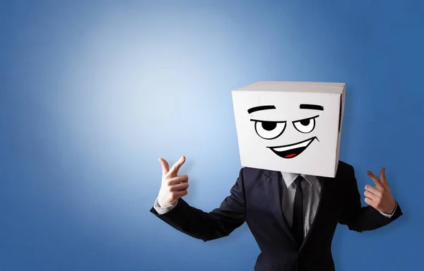 Young man with cardboard box on his head — Stock Photo, Image