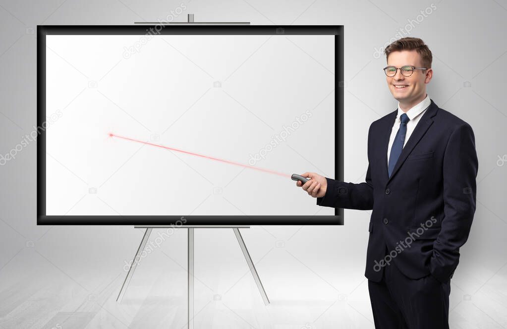 Businessman with laser pointer and copyspace white wall