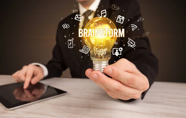 Businessman holding a light bulb, social media concept — Stock Photo, Image