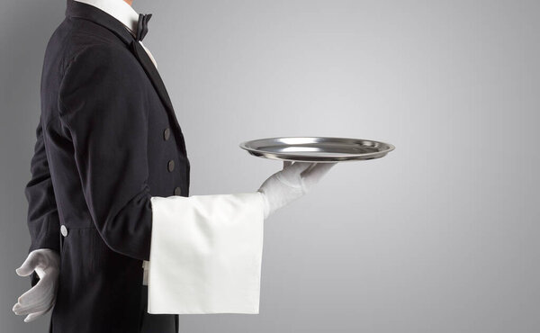 Waiter serving with white gloves and steel tray