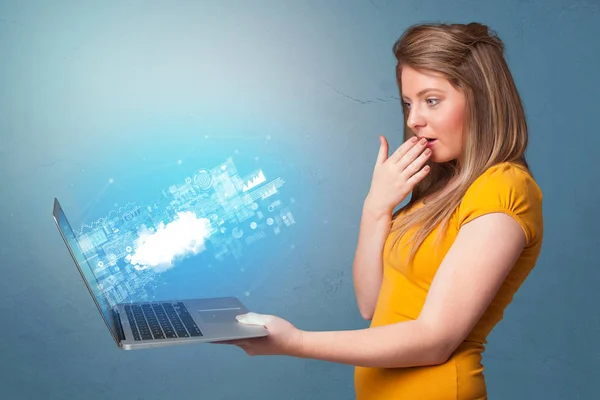 Woman holding laptop with cloud based system notifications — Stock Photo, Image