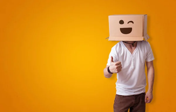 Funny man smiling with cardboard box head — Stock Photo, Image