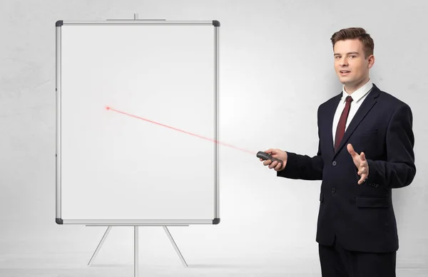 Businessman with laser pointer and copyspace white blackboard — Stock Photo, Image