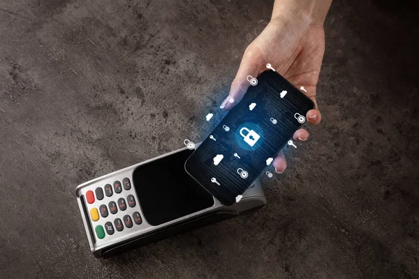 Hand paying with cellphone on POS — Stock Photo, Image