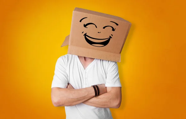 Young man with cardboard box on his head — Stock Photo, Image