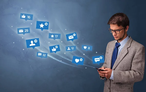 Young person using phone with social media concept — Stock Photo, Image