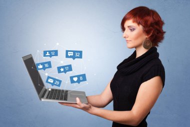 Woma holding laptop with social media notifications clipart