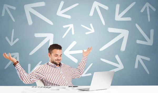 Business person sitting at desk with direction concept — Stock Photo, Image