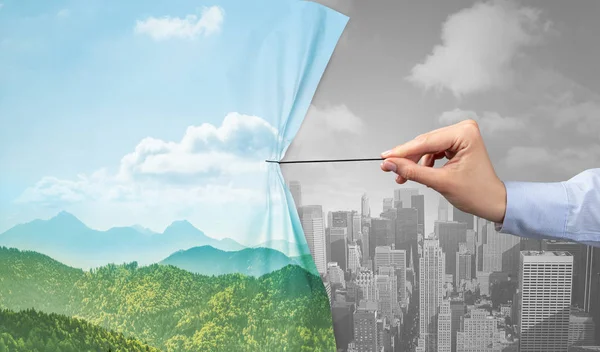 Hand pulling nature cityscape curtain to gray cityscape — Stock Photo, Image