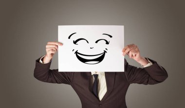 Bir kağıt doodle ifade yüzünün önünde tutan kişi