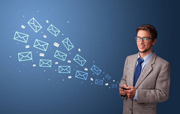 Businessman using phone with mail concept around