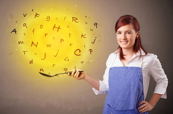 Person cooking letters in wok — Stock Photo, Image