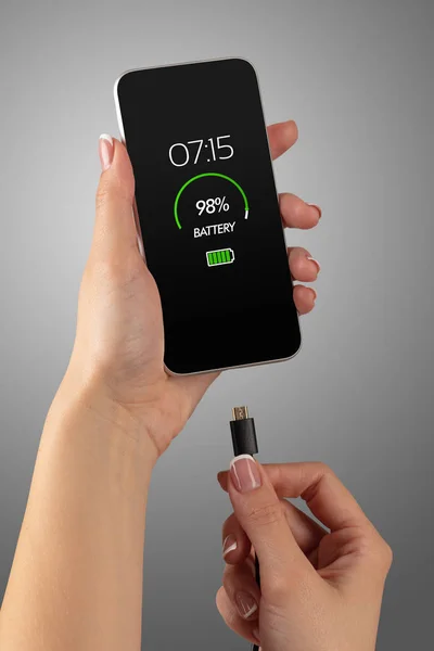 Hand charging phone with low battery — Stock Photo, Image