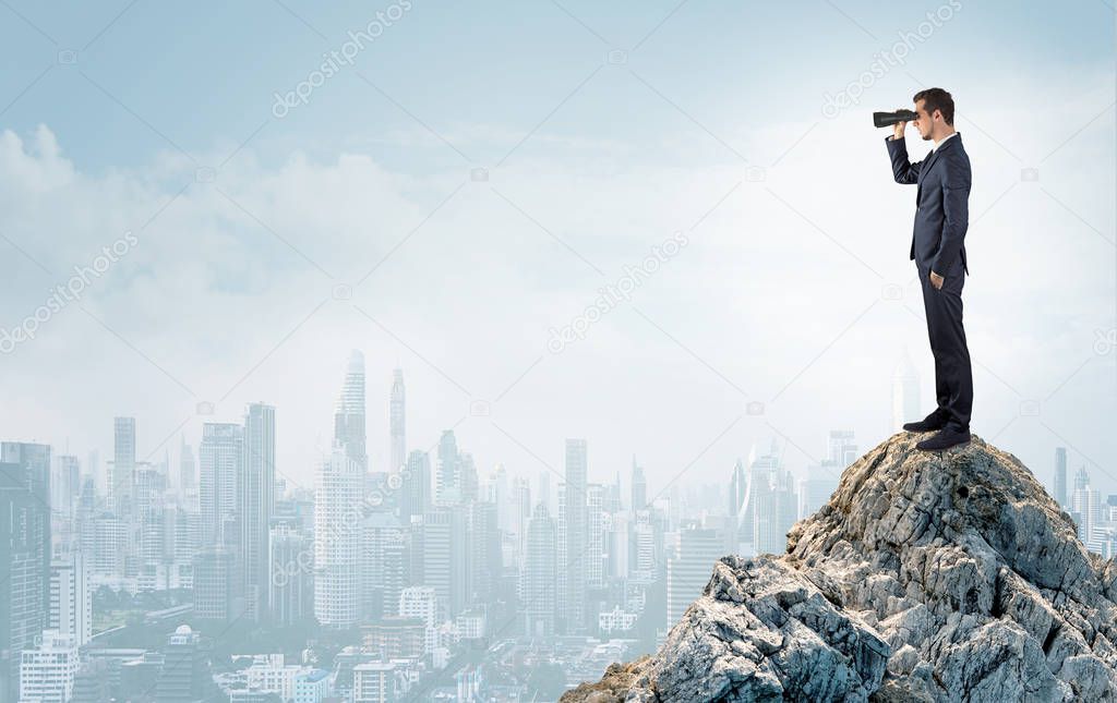 Business person looking to the big city from distance