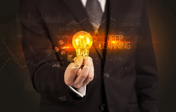 Businessman holding a lightbulb — Stock Photo, Image