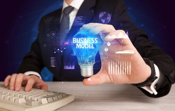 Businessman holding a light bulb, new business concept — Stock Photo, Image