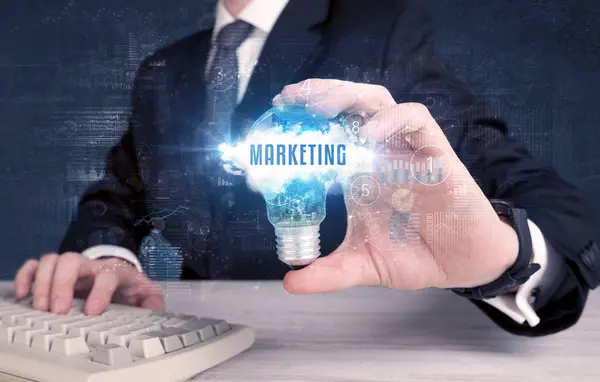 Businessman holding a light bulb, business concept — Stock Photo, Image