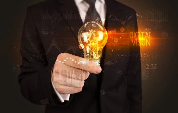 Businessman holding a lightbulb — Stock Photo, Image