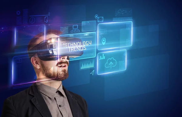 Businessman looking through Virtual Reality glasses, tech concept — Stock Photo, Image