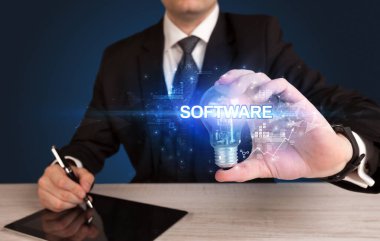 Elinde ampul tutan bir iş adamı.