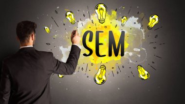 Adam renkli ampul çiziyor.