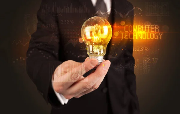 Businessman holding a lightbulb — Stock Photo, Image