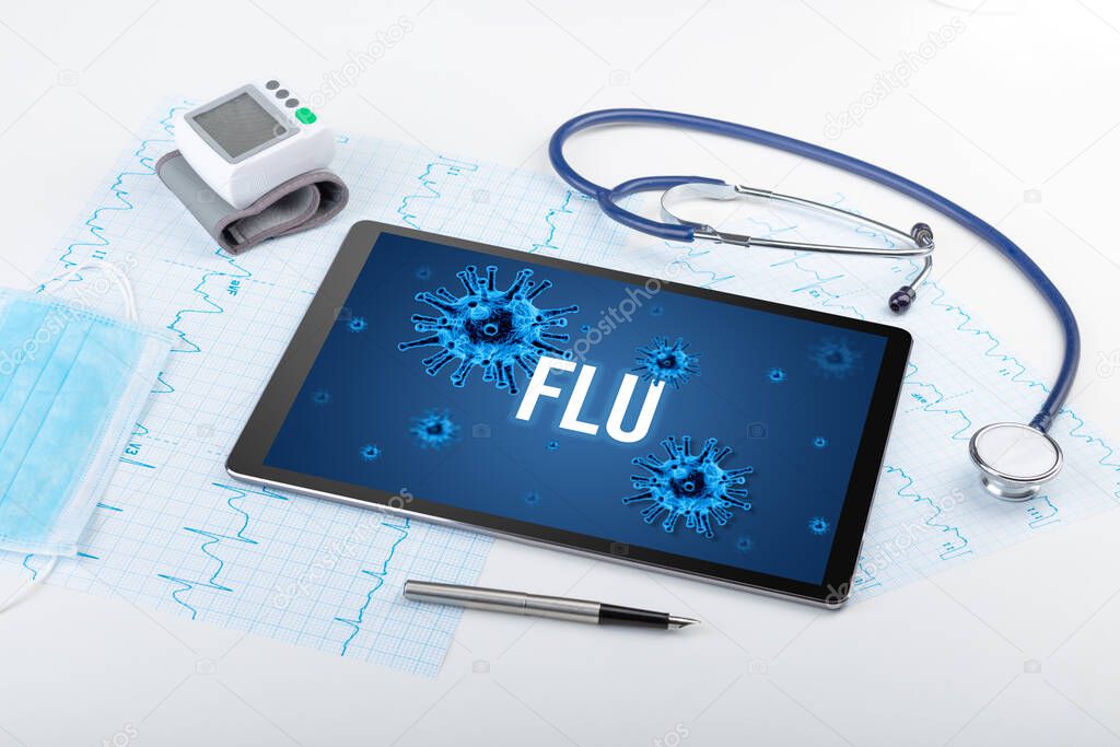 Tablet pc and doctor tools on white surface