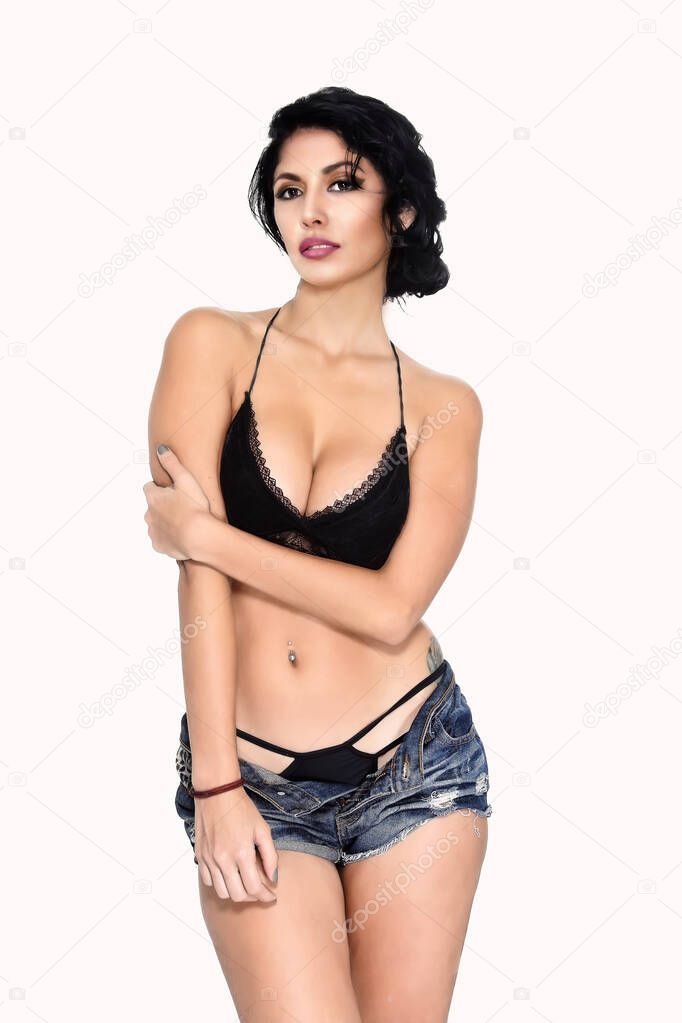 An image of a very attractive and sensual young Latin woman with a PINUP style, posing in medium shoot, wearing a bra, shorts and a panty, in an attitude of self-confidence and coquetry, color, studio,