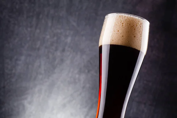 Tall glass of dark beer