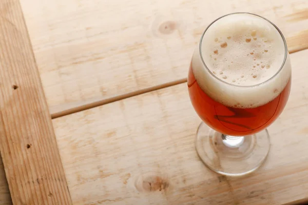 Red ale on light wood — Stock Photo, Image