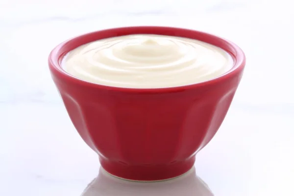 Red bowl plain yogurt — Stock Photo, Image