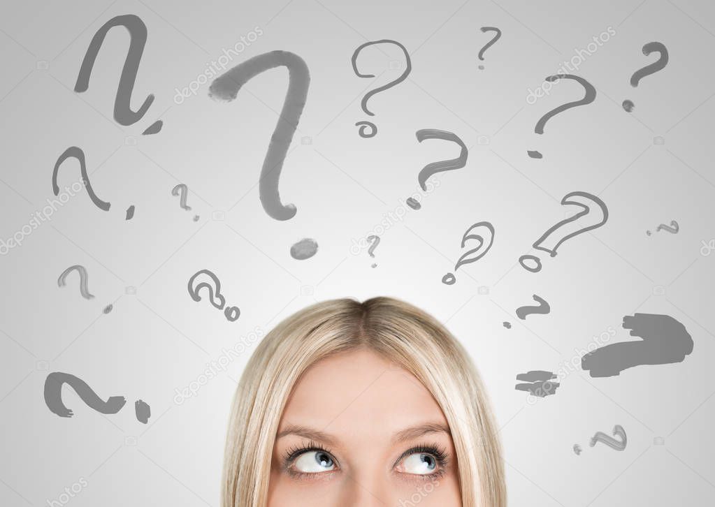 Confused woman with question amrks