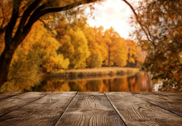 Old empty wooden table over the lake — Stock Photo, Image