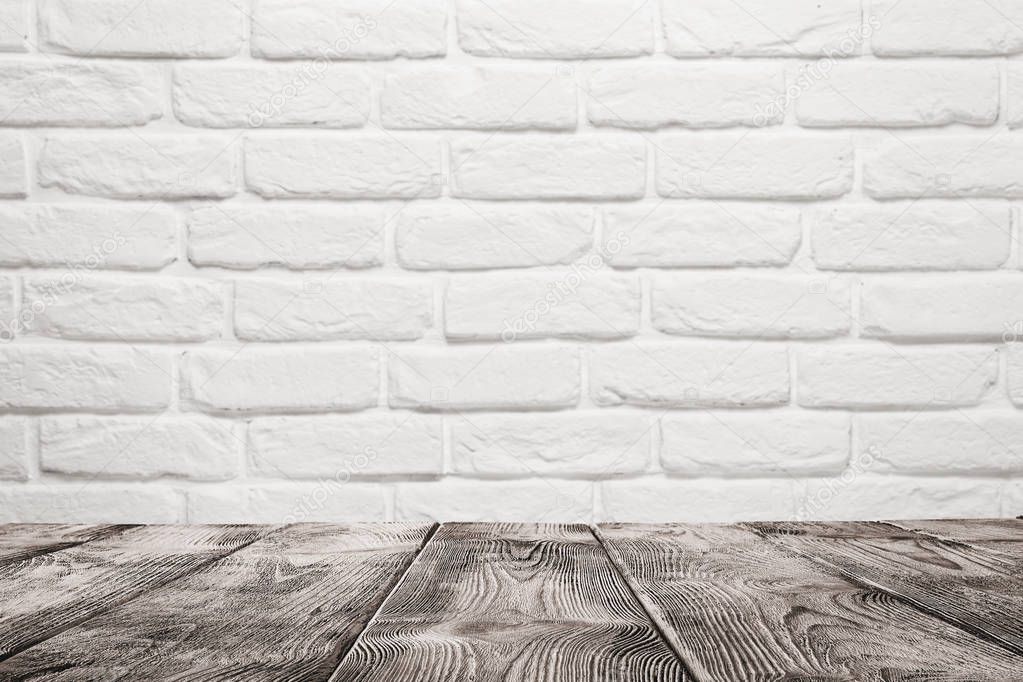 Empty table over white brick wall