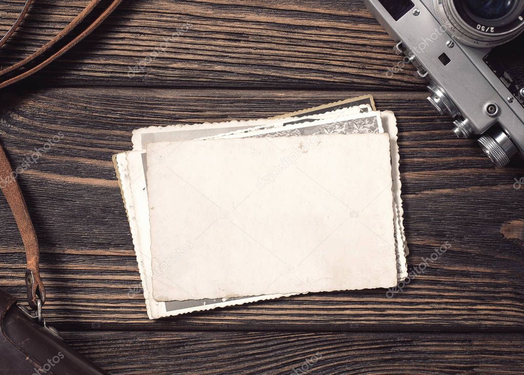 High angle view of a stack of old, blank photographs on the desk with copy 