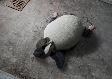High angle view of businessman crushed by the huge stone on the street with copy space  clipart