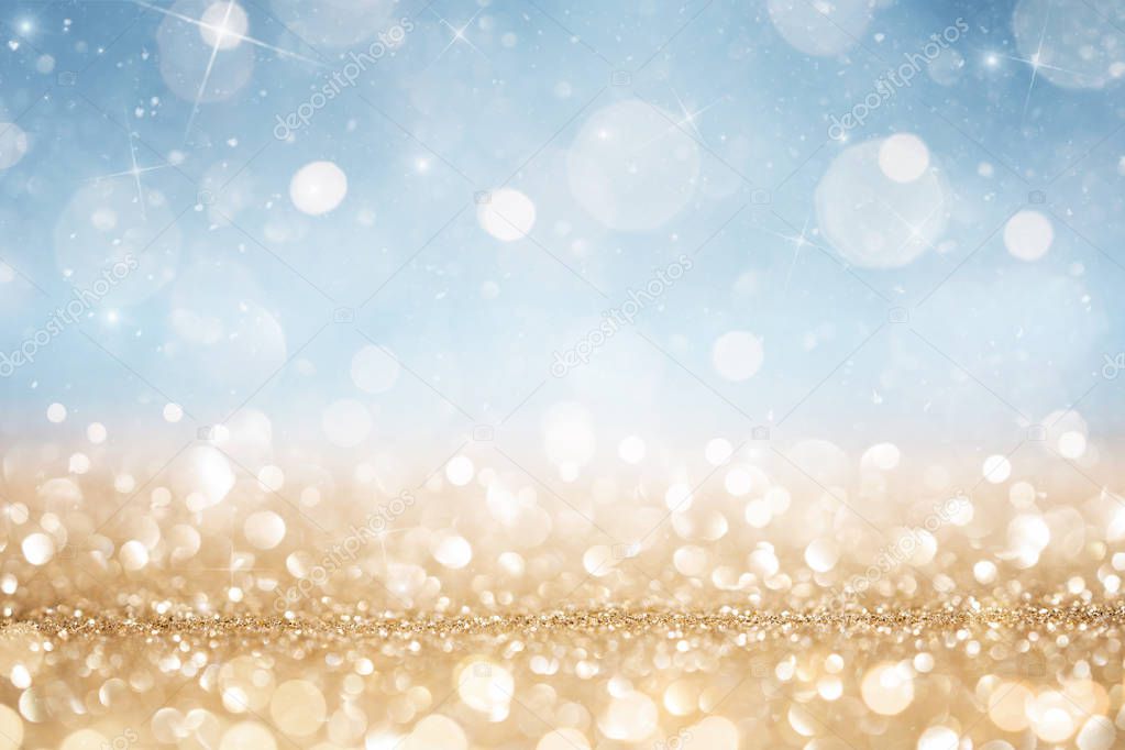 Abstract defocused gold and blue glitter background
