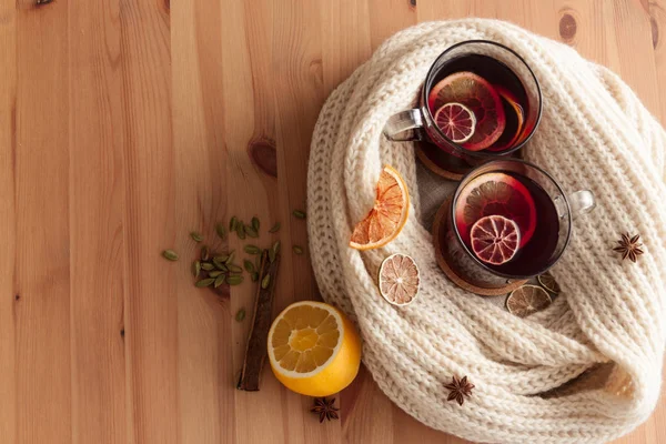 Seasonal and holidays concept Christmas mulled wine with beautiful orange slices inside the glass , covered with warm white scarf . Very warm and cozy atmosphere — Stock Photo, Image