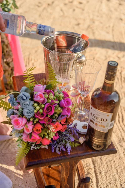 Wedding bouquet on the table with alcohol