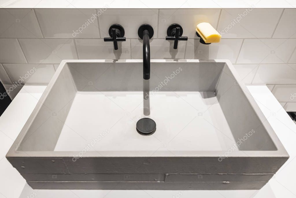 concrete hand wash basin with black tap