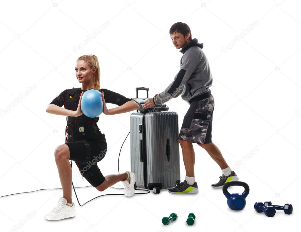 EMS fitness woman doing ball exercises with coach