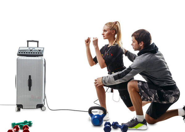 EMS fitness woman doing lunge exercise with coach