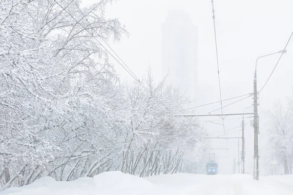 Eléctrico vai ao longo da rua durante tempestade de neve no inverno em Moscou — Fotografia de Stock