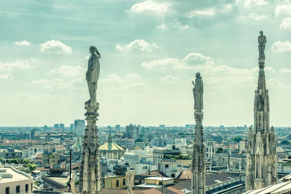 Marble statues of Milan Cathedral overlooking Milan