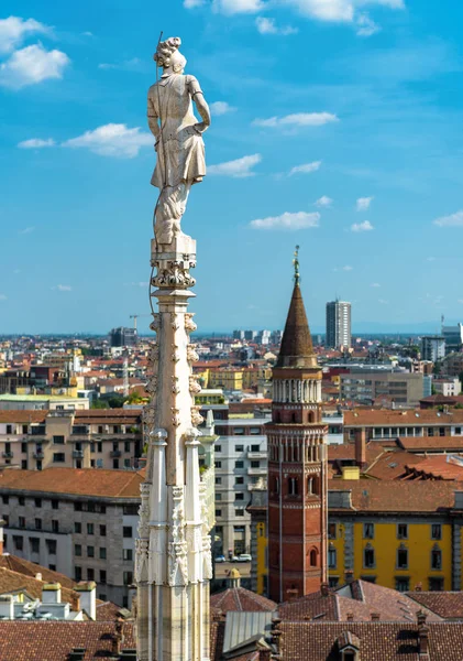 Statue on spire of Milan Cathedral on blue sky background, Milan — Stok fotoğraf