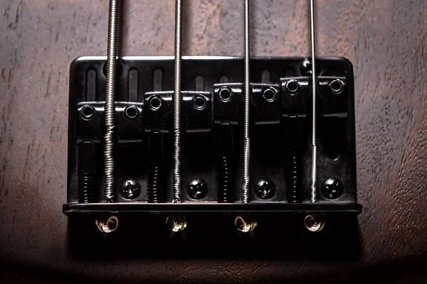 Bass electric guitar with four strings closeup. Detail of popula