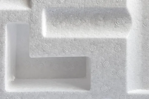 Polystyrene or styrofoam padding for product packaging. Detail of styrene foam plastic box close-up. White styrofoam cushion texture background. — Stock Image Polystyrene Styrofoam Padding Product Packaging Detail Styrene Foam Plastic Box Royalty Free Stock Photos