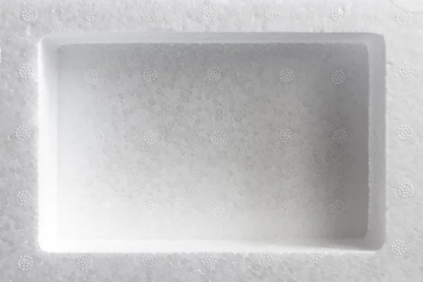 Polystyrene or styrofoam padding for product packaging. Detail of styrene foam plastic box close-up. White styrofoam cushion texture background. — Stock Image Polystyrene Styrofoam Padding Product Packaging Detail Styrene Foam Plastic Box Stock Photo